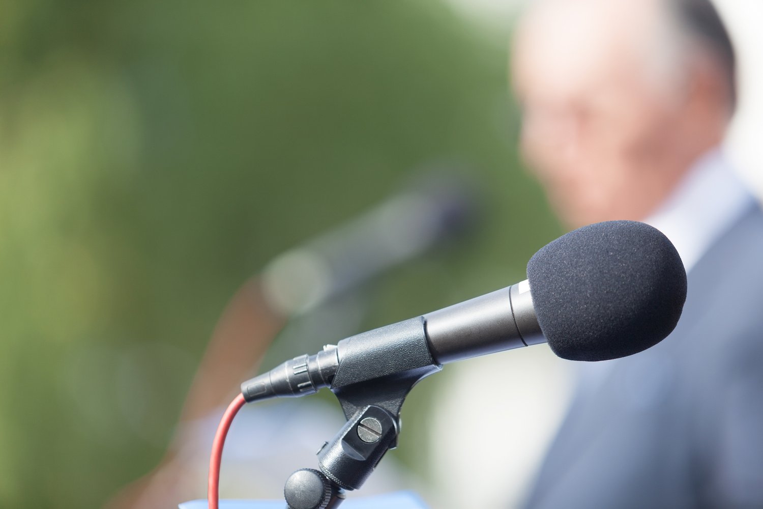 Political campaign. Press conference. Microphone. Speaker. Speech.